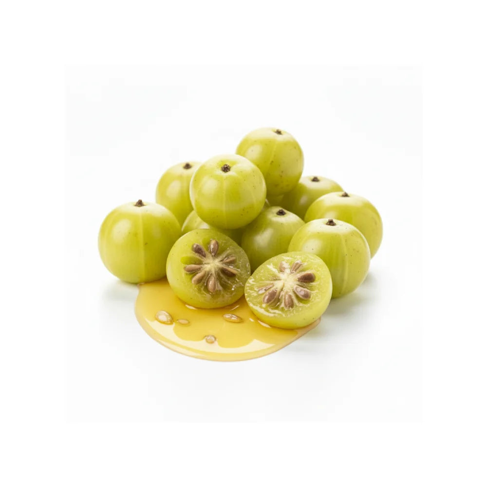 Amla fruit with a cut one showing seeds, on a white background