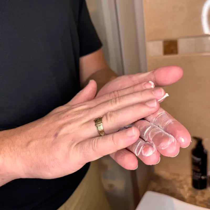 man rubbing in matte clay in to hands