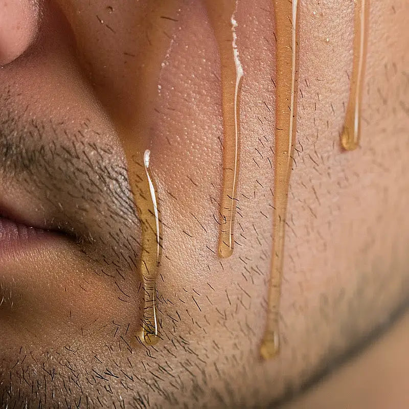 Man with shave oil running from his face