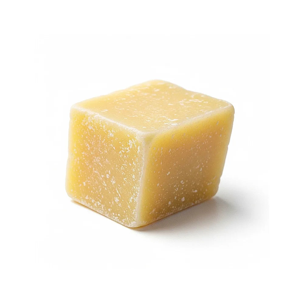 Cube of rice wax on a white background