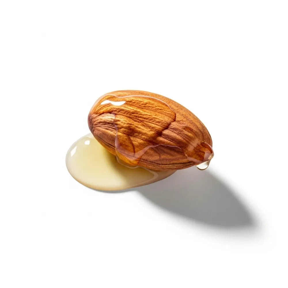 Almond with a droplet of oil on a white background