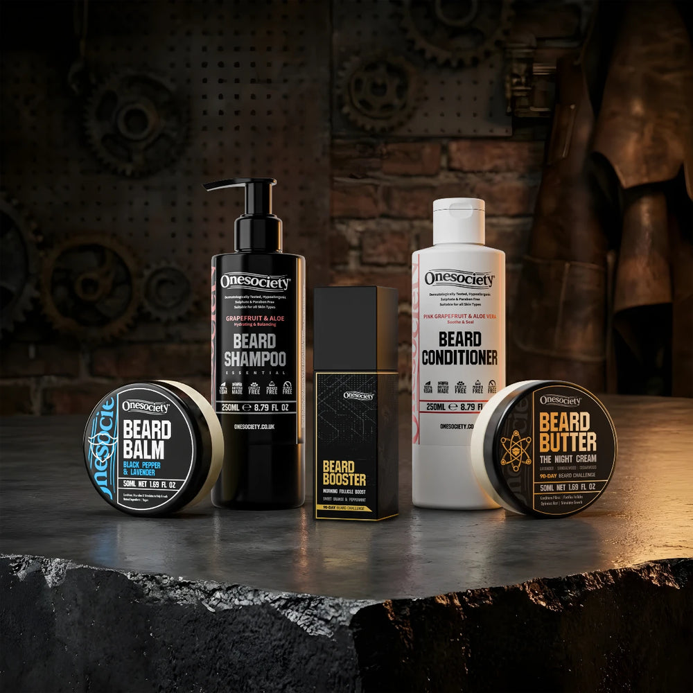 Collection of Onesociety beard care products on a dark surface with a rustic background. 90 Beard Beard Challenge.