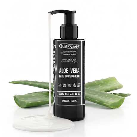 A bottle of Onesociety Aloe Vera Face Moisturiser standing upright on a white background, with a white cream pool at its base and aloe vera slices arranged behind it.