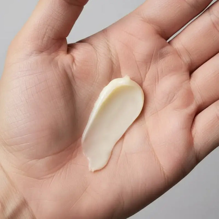 Hand holding one society beard balm