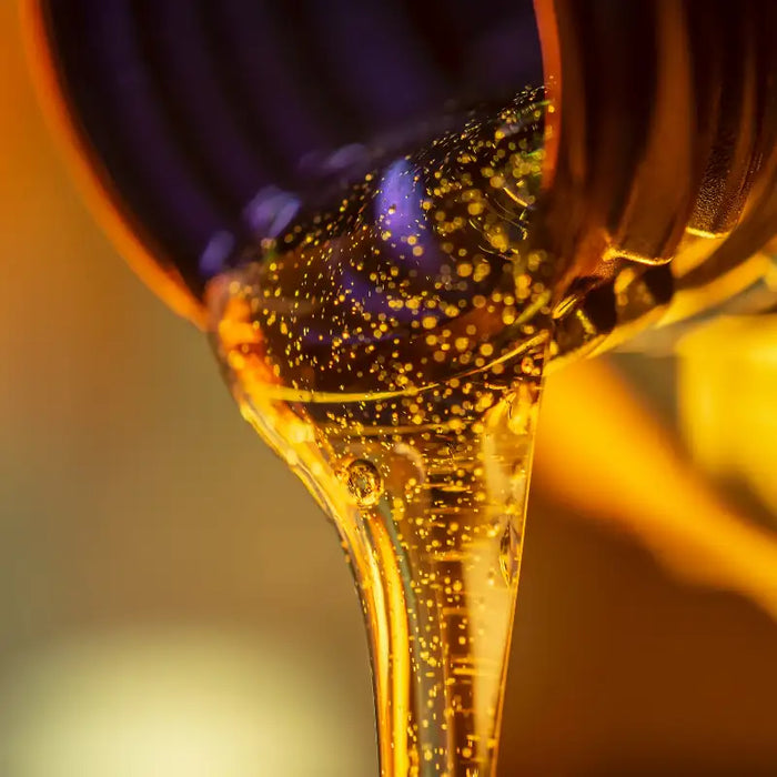 Beard Oil by one society flowing out of bottle