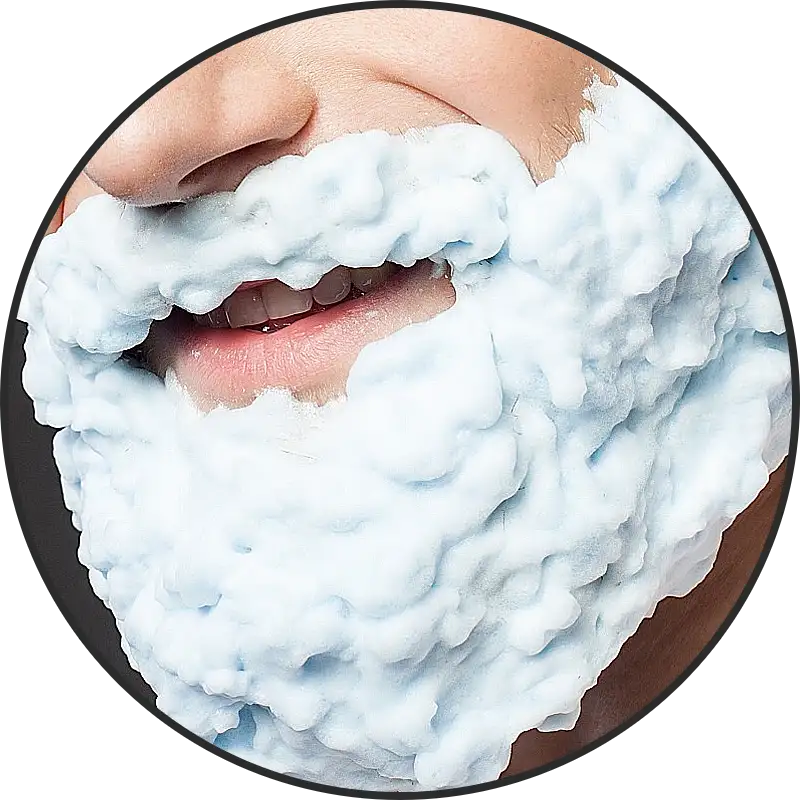 man smiling with beard shampoo on his face