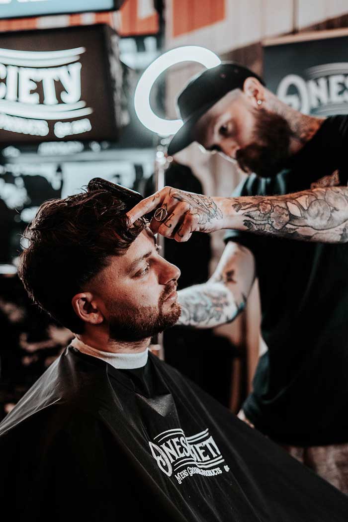 one society barber Dan hall from the tin can barbers cutting at great British barber bash stand London