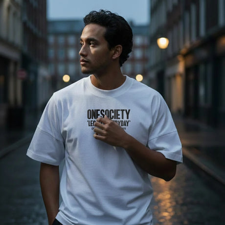 Man wearing a white t-shirt with text on a city street