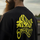 Person wearing a black jacket with yellow 'Onesociety' logo