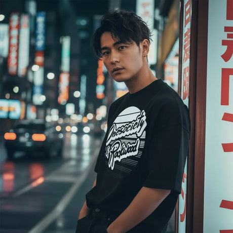 Man standing on a city street at night with neon signs in the background