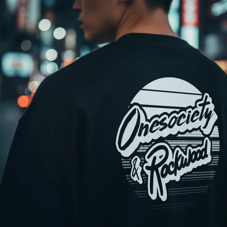 Person wearing a black sweatshirt with 'Onesociety & Rockwood' logo in an urban setting