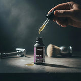 Rhubarb and vanilla beard oil by one society with lid off and shaver in the background