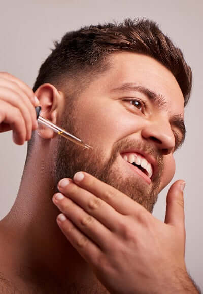 one society man using beard oil