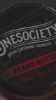 One society Beard Butter Being used by a barber, great for stumlating beard growth and a healthier thicker beard. Made in the UK with natural vegan ingredients, made for men.