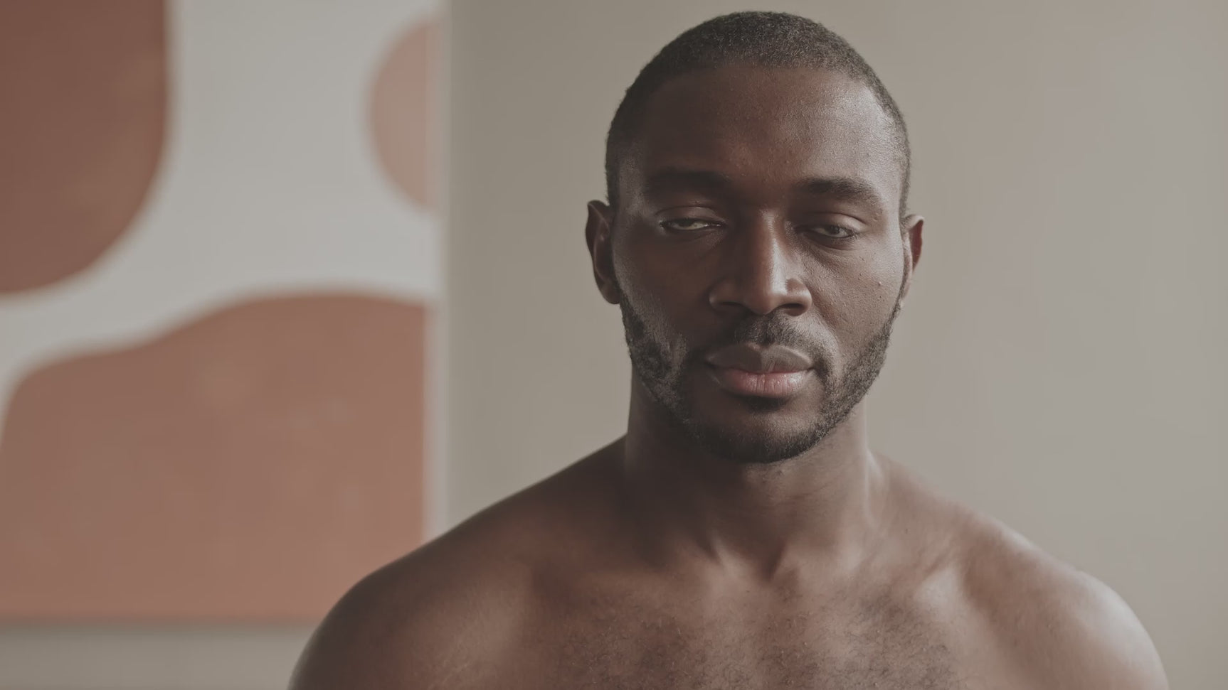 One society man applying aloe Vera moisturiser gel on to his face. Onesociety men's skin care products.