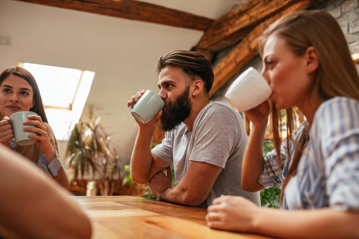 Man with nice big beard drinking hot chocolate with beautiful women.