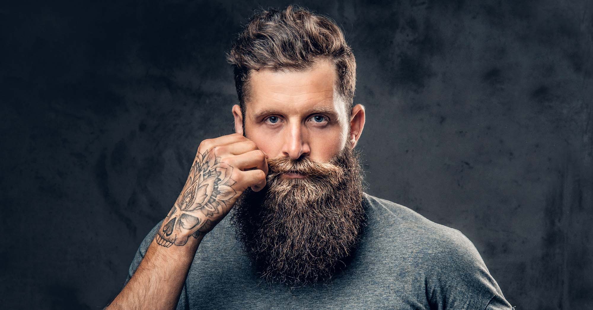 man with big beard using beard care products such as beard oil beard balm beard butter to help maintain a good looking and healthy thick beard.