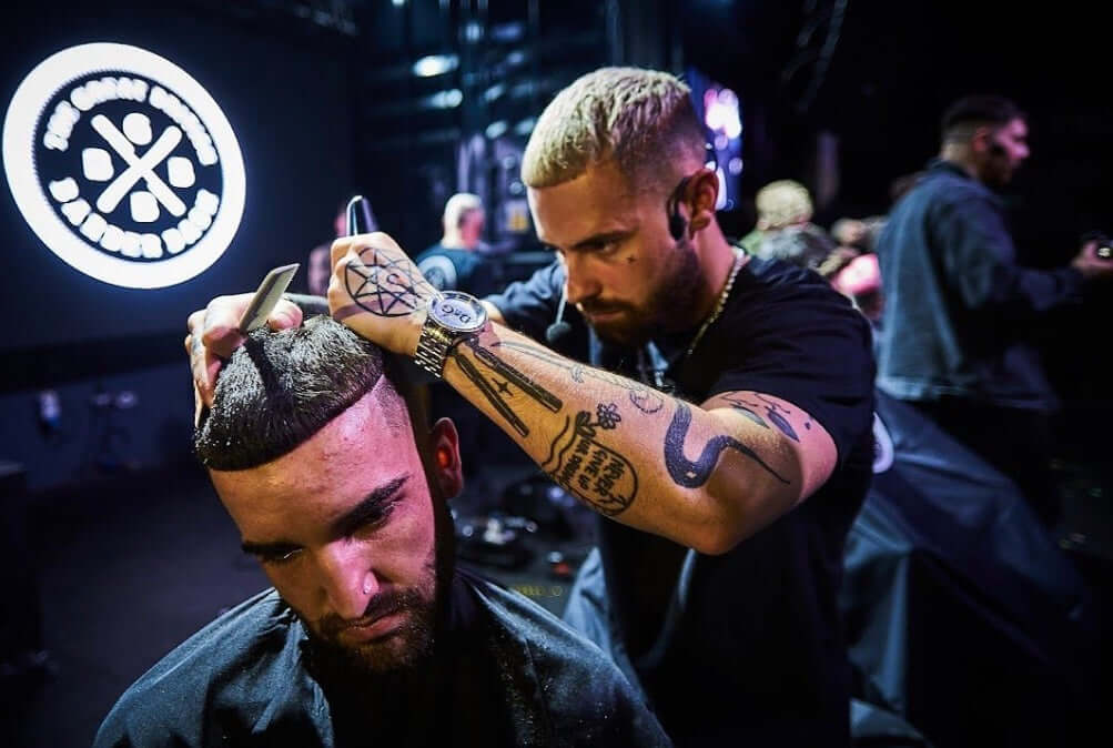 Callum Butler making a skin fade on mans hair at the Great British Barber Bash.